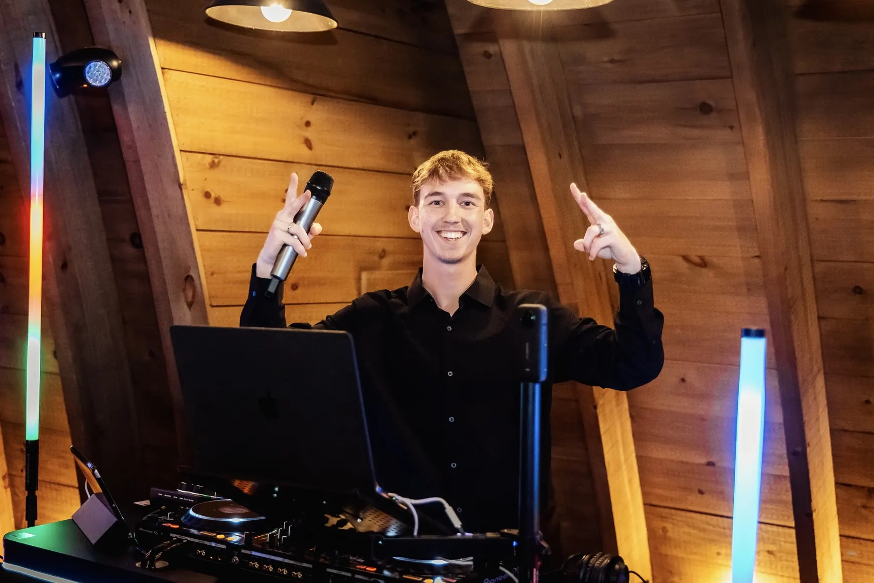 Nick, DJ and owner of The Vibe – Events & Weddings, smiling at the DJ booth