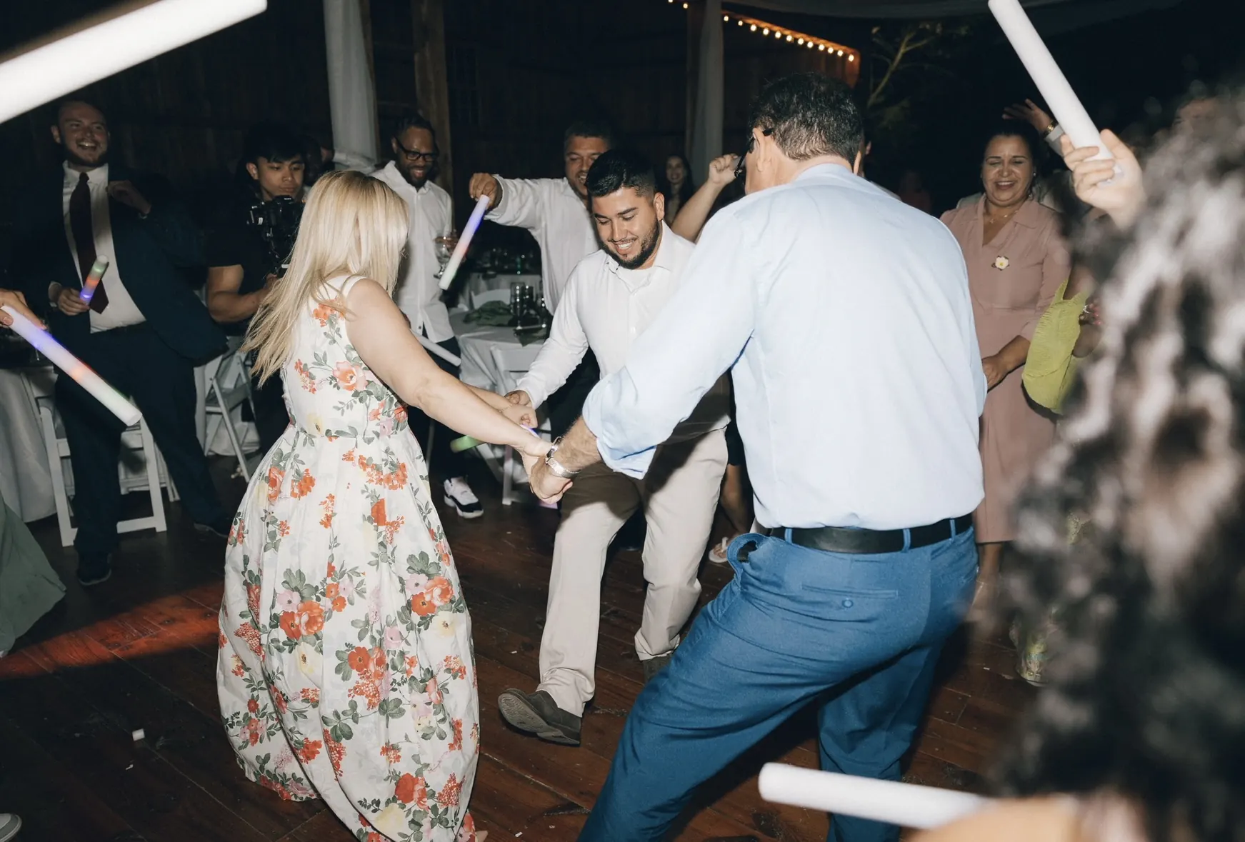 Guests dancing and holding hands on a wedding dance floor